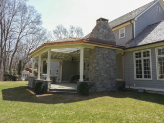 AFTER - GREENWICH CT Roof over patio with a huge custom skylight Build in outdoor kitchen grill and fireplace. Best local Builder