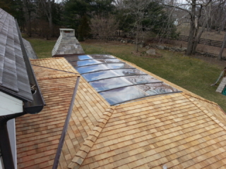 AFTER - GREENWICH CT Roof over patio with a huge custom skylight Build in outdoor kitchen grill and fireplace. Best local Builder