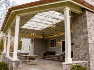 AFTER - GREENWICH CT Roof over patio with a huge custom skylight Build in outdoor kitchen grill and fireplace. Best local Builder