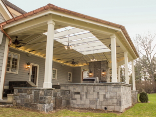 AFTER - GREENWICH CT Roof over patio with a huge custom skylight Build in outdoor kitchen grill and fireplace. Best local Builder